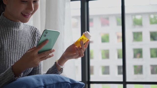 Asian Girl reading information online on mobile phone&nbsp;medicine