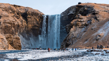Skogafoss Waterfall with Tourists in Winter, Iceland © lee
