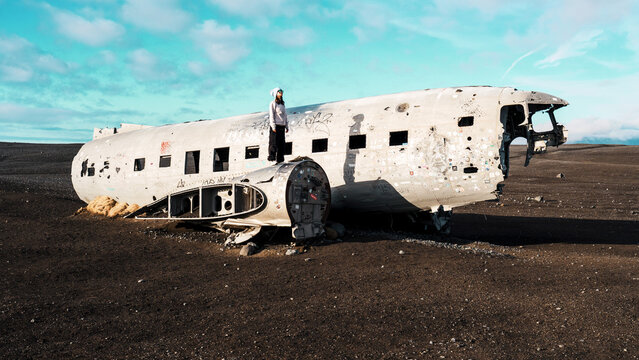 Woman Standing on Abandoned DC-3 Plane Wreck, Iceland