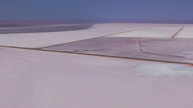 Aksaray, Turkey. Aerial drone view of Tuz Golu salt lake near Sereflikochisar showing geometric salt evaporation ponds, mining fields and straight access roads under summer sun.. Aerial View