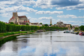Fototapeta premium Scenic cityscape of Auxerre with Saint Stephen Cathedral and Saint Germanus Abbey reflected in the Yonne river in Burgundy, France