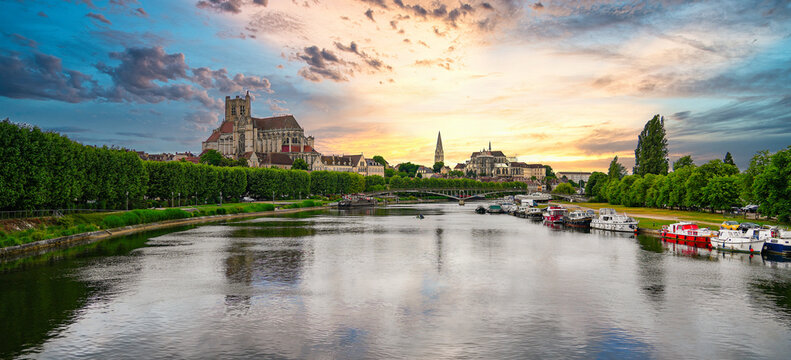 Scenic cityscape of Auxerre with Saint Stephen Cathedral and Saint Germanus Abbey reflected in the Yonne river in Burgundy, France