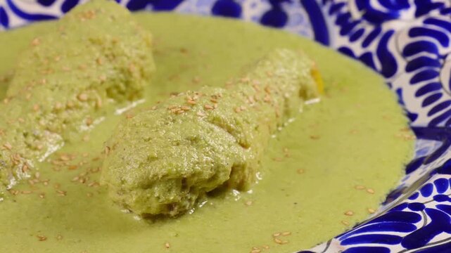 Authentic green mole or pipian with chicken legs and sesame seeds garnish