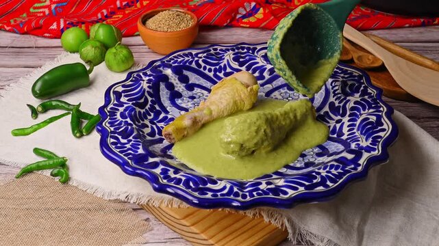 Green pipian with fresh tomatillos and serrano peppers, pouring green sauce