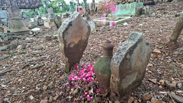 Grave with Tombstone Covered in Rose Petals as Indonesian Mourning Tradition