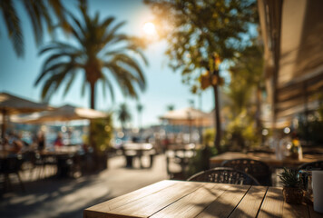 Fototapeta premium blurred background of an outdoor cafe with the sun and palm trees. vintage tone effect. concept for a summer vacation, travel, or lifestyle.