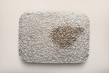 Clumping cat litter filler, taken without a drawer, as if in glass, top view, pet hygiene concept with absorbent used cat litter filler with a lump to combat odor and absorb moisture, pet care product