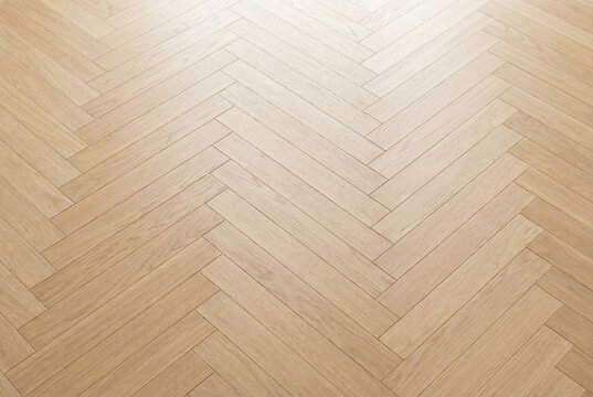 Light wood herringbone parquet flooring texture background
