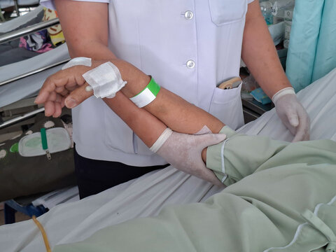 Position the arms or assist with physical therapy/joint mobilization for patients lying in a hospital bed.
