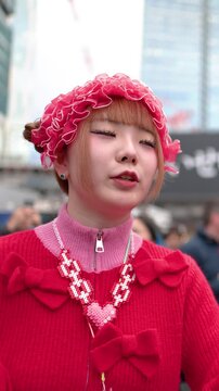 Japanese Woman in Pink Decora Fashion Talking at Shibuya Crossing Tokyo
