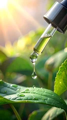 Fototapete Krankenhaus A dropper dispenses a single drop of liquid over green leaves  © telor