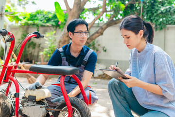 Obraz premium Female Startup Founder and Engineer Test Minibike Prototype at Small Business Workshop