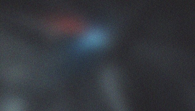 Red and blue light spots on dark grainy textured background abstract