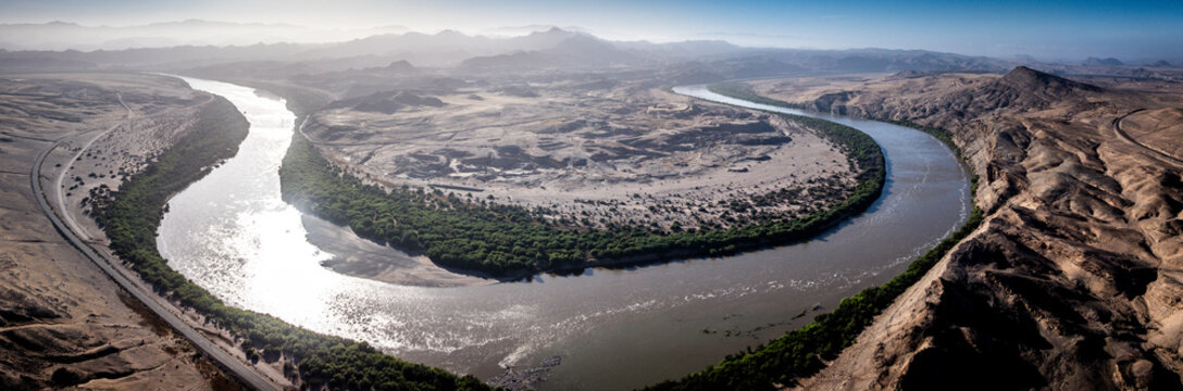 Panoramic aerial view of the diamond-producing area near the Auchas Pass between Rosh Pinah and Oranjemund in Namibia, showing the Orange River, the border with South Africa, and exploration areas