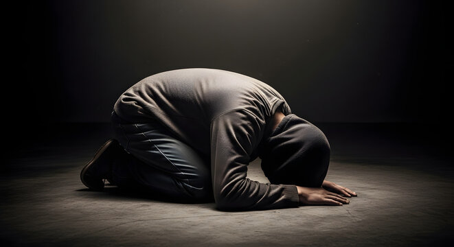 Person Kneeling in Prayer Posture.