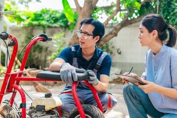 Obraz premium Female Startup Founder and Engineer Test Minibike Prototype at Small Business Workshop