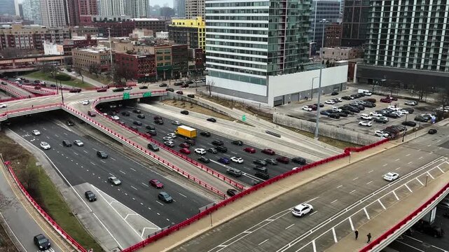 An Aerial view of Chicago's Highways as cars drive and sit in traffic along the outside of downtown.