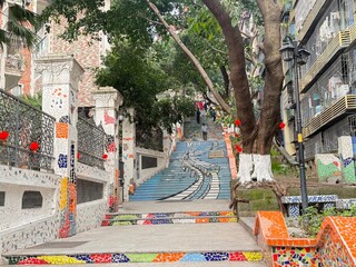 colorful mosaic stairs with urban street art painting in a local neighborhood of chongqing, china
