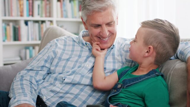 Grandpa, phone and teasing with boy on sofa in home living room for bonding, laughing or visit. App, love and playful senior man pinching cheek of grandson in apartment for connection or security