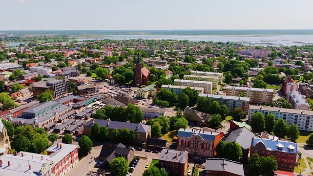 Aerial establishing shot of Liepaja, Latvia with urban layout and sea horizon