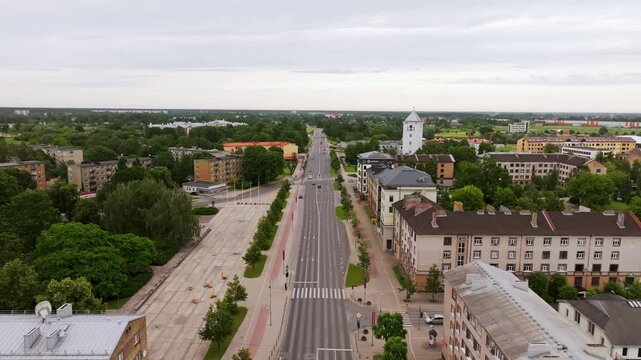 Drone pull back of Jelgava Latvia avenue with Trinity Church and bird flying