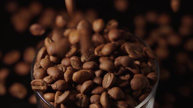 High angle shot of coffee beans being poured in a cup
