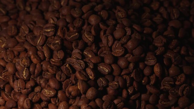 Static shot over a pile of coffee beans. Going from light to dark.