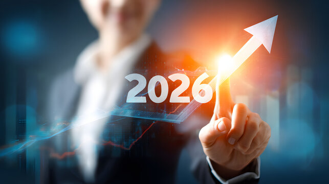 A businesswoman pointing to a bright future in 2026 with optimism and growth
