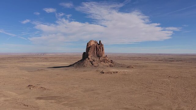 Drone view captures a remote sci-fi outpost monolith on a barren desert planet, highlighting the isolated rock formation within a desolate and vast futuristic wilderness environment.