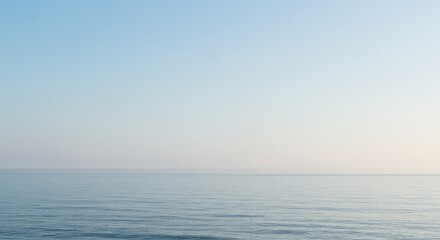 Fototapeta premium A peaceful, empty seascape featuring a soft, featureless horizon line merging the sky and calm ocean. Pure, expansive background, simple, white, calm