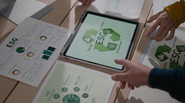 ESG,Business team analyzing esg sustainability data charts,executives discuss environmental sustainability ESG reports for corporate responsibility,global warming,ESG strategies,green future planning
