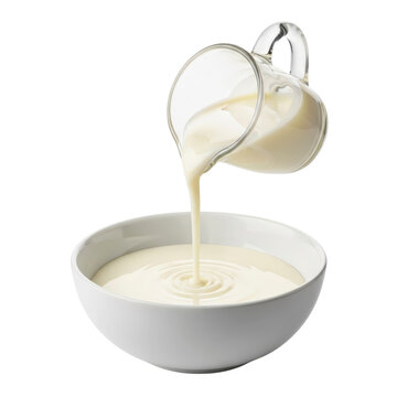 Cream pouring from jug into bowl