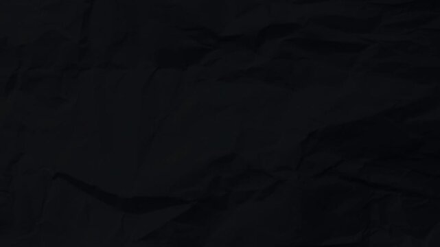 Black crumpled paper background animation. Horizontal motion graphic with dark wrinkled texture. Minimalist noir style for video overlays and cinematic backdrops.