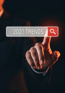 Person searching for future trends online with finger hovering over a search button on a dark screen.