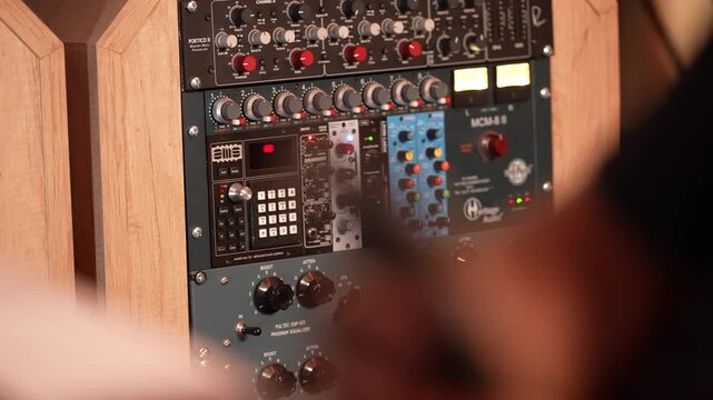Professional audio rack equipment with processors and equalizers. Recording studio gear, sound processing units, mixing console modules. Music production hardware in wooden rack mount.