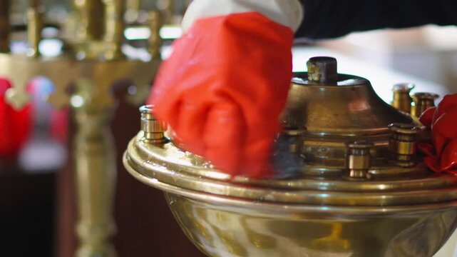 Preparing for Easter ,polishing brass candle holders in an Orthodox sanctuary.