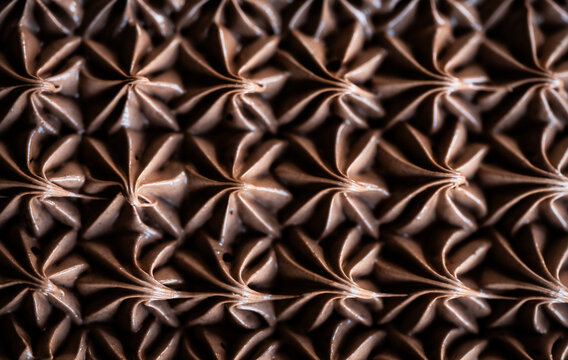 Close up of chocolate icing pattern on cake from above.