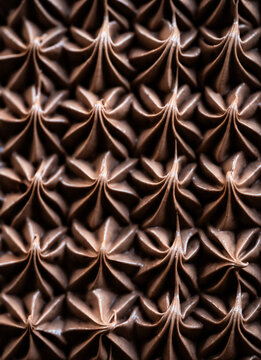 Close up of chocolate icing pattern on cake from above.