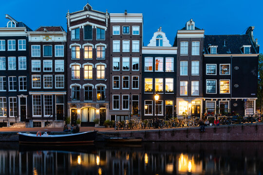 Amsterdam row houses illuminated in the evening