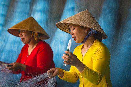 Women repairing fishing nets in Vietnam