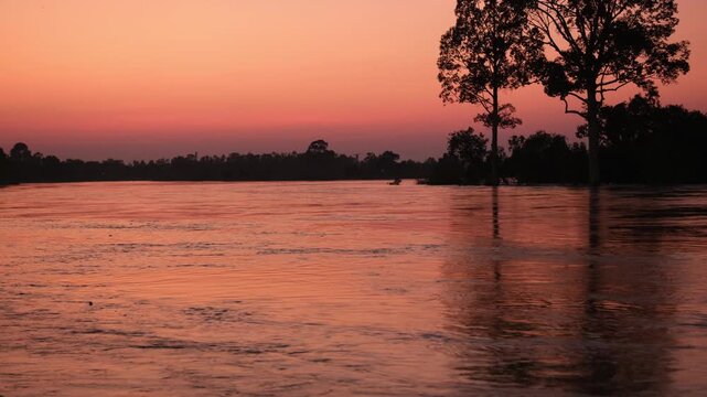 flooded in rainy season extreme weather climate change concept. rising moon river water covering paddy field, rural pathway and submerging countryside landscape during storm season in thailand.