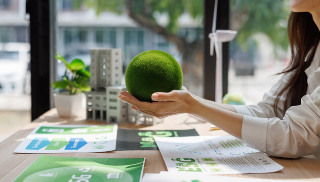 Hands holding green sphere representing corporate esg concept