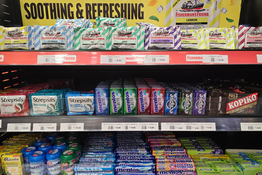 Bayan Lepas, Malaysia - Jan 21, 2026: Various brands of throat lozenges and mints including Fisherman's Friend, Strepsils, Mentos, and Eclipse displayed at a WHSmith store in Penang Airport.