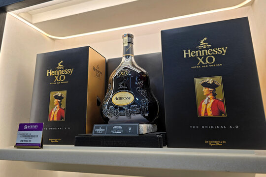 Bayan Lepas, Malaysia - Jan 21, 2026: A large bottle of Hennessy X.O Extra Old Cognac showcased alongside branded gift boxes at a luxury duty free display in Penang International Airport.