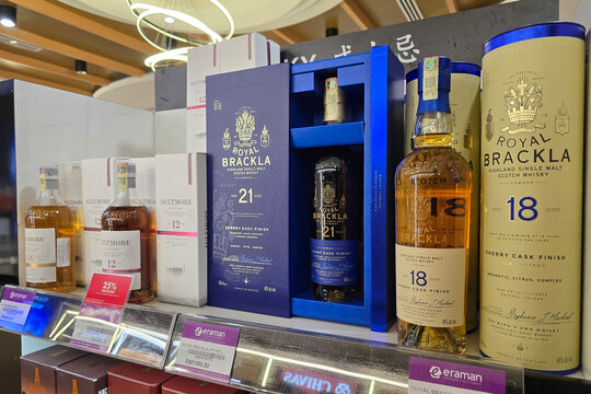 Bayan Lepas, Malaysia - Jan 21, 2026: Various bottles and gift boxes of Chivas Regal 12-year-old and Royal Salute 21-year-old blended scotch whisky at an Eraman duty-free shop in Penang Airport.