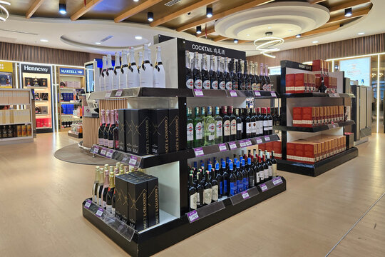 Bayan Lepas, Malaysia - Jan 21, 2026: A prominent retail display featuring multiple bottles and gift boxes of Martell Cordon Bleu Extra Old Cognac at an Eraman duty-free shop in Penang Airport.