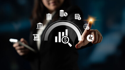 A business professional assesses financial data using digital tools, showcasing graphs and icons...