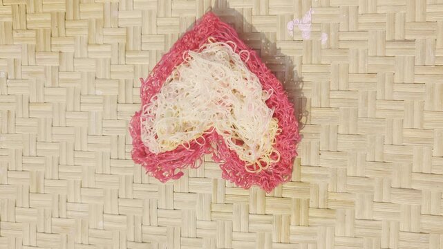 String hoppers heart shape on woven bamboo mat ethnic food vermicelli noodle dish sri lankan cuisine