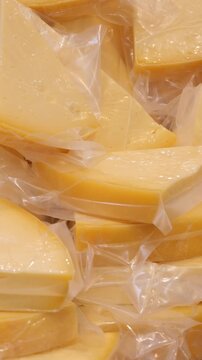 Cheese slices are packed and ready for sale in a shop