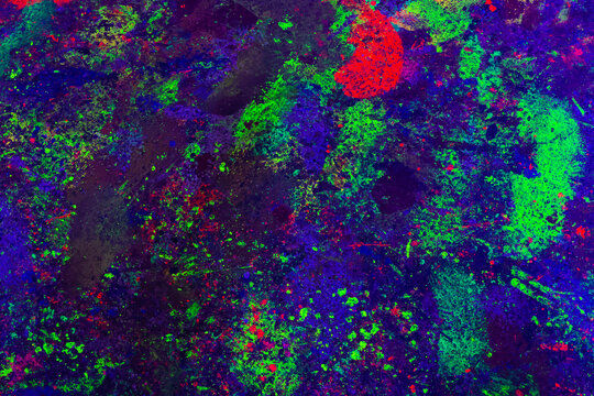 Deep Blue UV-Reactive Paint Splashes With Neon Streaks Glowing Under Blacklight